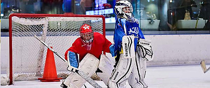 A goalie and player at the hockey tournament